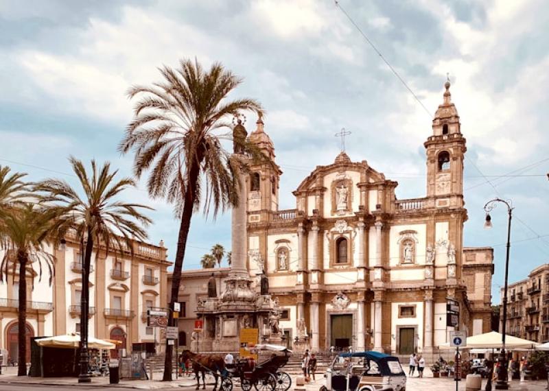 Church in Palermo with palm trees in the foreground