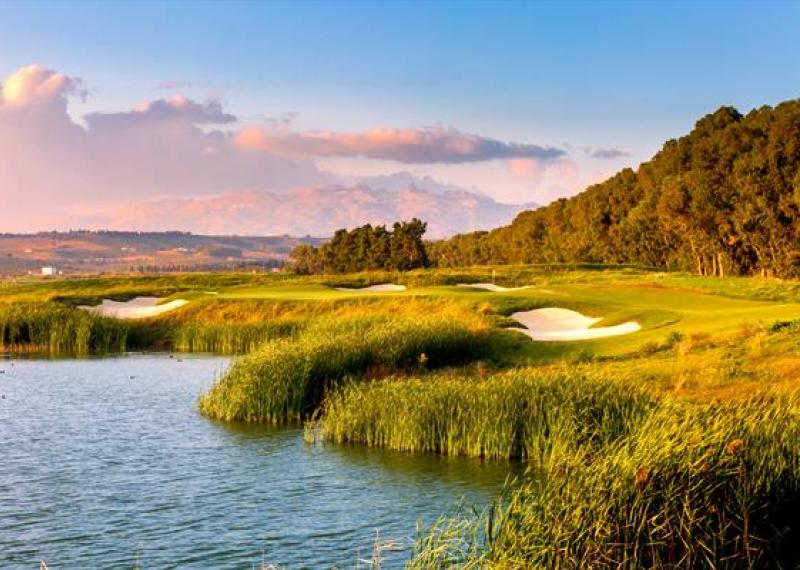 east course at Verdura Resort with water and vegetation in the background